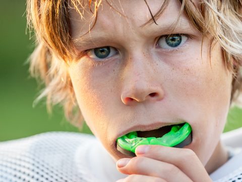 Boy putting in his sports mouth guard