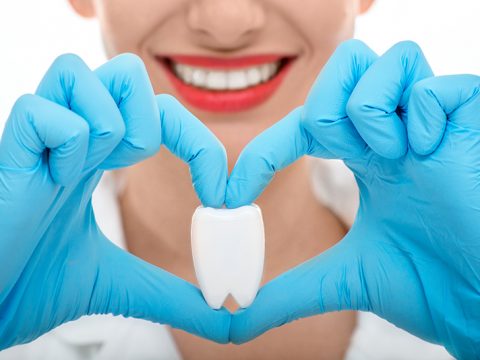 dentist making heart around tooth