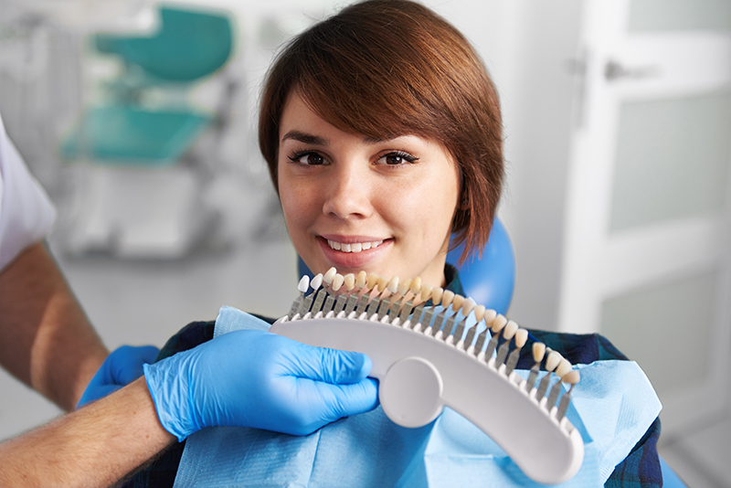 woman undergoing teeth whitening at the dentist